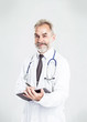© yurolaitsalbert - experienced therapist with a stethoscope on light background.