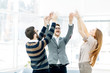 © yurolaitsalbert - concept of victory - the jubilant business team standing in a circle, hands up in rejoice success.