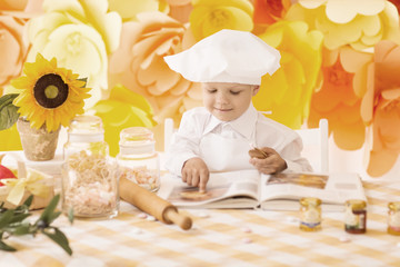 happy little boy with a book chef preparing Breakfast the kit