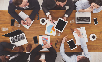 Group of busy business people working in office, top view