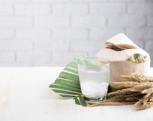 Poster - Coconut juice,Drink coconut water on table against white brick wall