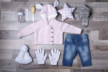 Wall Mural - Baby clothes and accessories on wooden background