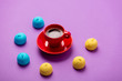 photo of tasty colorful marshmallows and cup of coffee on the wonderful purple background