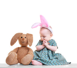 Cute funny baby with bunny ears and cuddly toy on white background