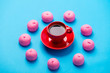 photo of tasty pink marshmallows and cup of coffee on the wonderful blue background