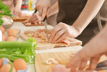 Man Cutting Chicken Fillet At Cooking Classes