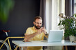 © chika_milan - Young entrepreneur using smart phone while sitting in his personal home office