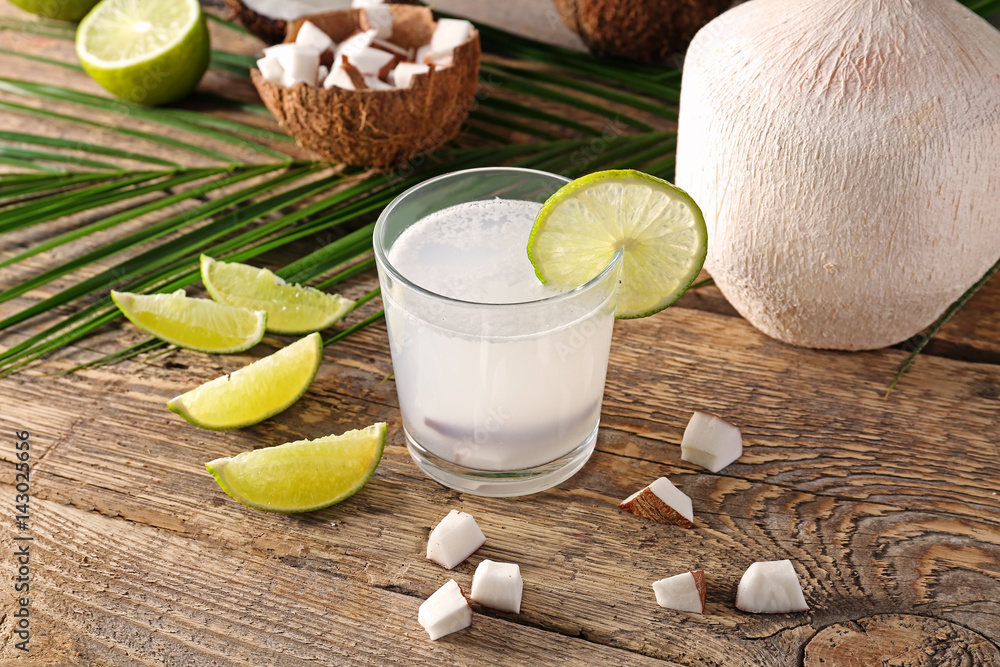 Composition with fresh coconut milk on wooden table
