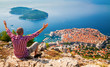 man with opened arms looking down to the Old Town of Dubrovnik