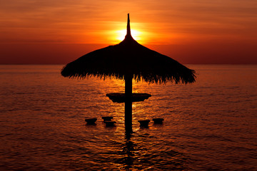 Wall Mural - parasol silhouette at beautiful sea tropical sunset
