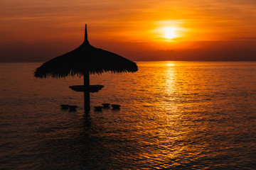 Wall Mural - parasol silhouette at beautiful sea tropical sunset