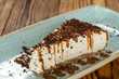 Tasteful. Cropped shot of a sweet cheesecake served with caramel and chocolate chips on it.