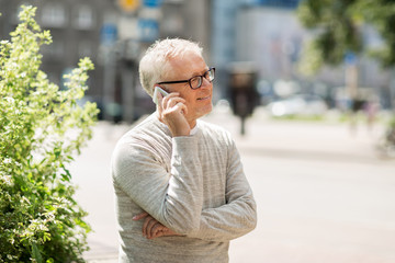 Poster - happy senior man calling on smartphone in city