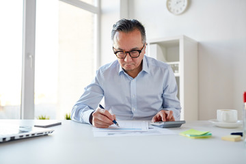 Sticker - businessman with calculator and papers at office