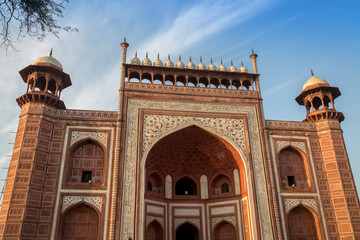 Fototapete - Taj Mahal west gate close up - A beautifully crafted red sandstone structure bearing the heritage of Mughal architecture in India.