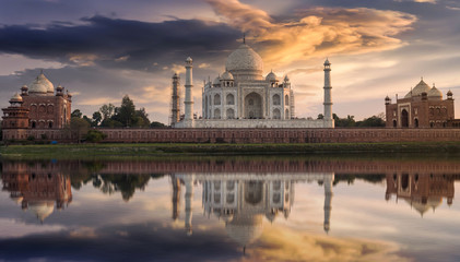 Fototapete - Taj Mahal Agra at sunset as seen from the Yamuna river banks with a moody sky. Taj Mahal designated as a World Heritage Site is a masterpiece of Indian heritage and architecture.