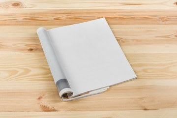 Mock-up magazine or catalog on natural wooden table. Blank page or notepad on wood background. Blank page or notepad for mockups or simulations.