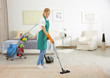 © Africa Studio - Woman cleaning carpet with vacuum cleaner