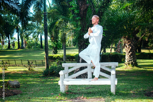 Man Standing In Asana On Bench Young Man In White Clothing