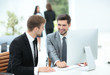 © ASDF - Two successful business men discussing documents in a modern off