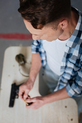 Wall Mural - Top view of a man reloading his handgun