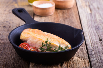 Canvas Print - Fried chicken breast on skillet with tomatoes