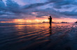 © Theerawat - Silhouette, man taking a picture with a smartphone on the beach and wonderful sky at sunset. Andaman seaThailand