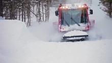 Red Snow Groomer In Forest - Picture With A Modern Snow Groomer Near A Snowy Forest