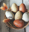 Decorative Easter eggs in wooden basket on Wooden Underground