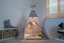 Girl Playing In The Teepee