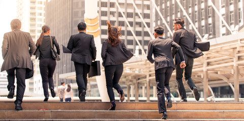 Business people running in city