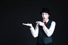 Mime Shows At Something Invisible On His Palm