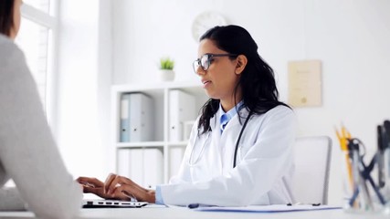 Wall Mural - doctor with clipboard and laptop and woman