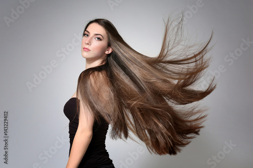 Beautiful Young Woman With Long Straight Hair On Light Background