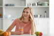 © Africa Studio - Young woman tasting fresh juice at kitchen