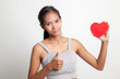 © halfbottle - Asian woman thumbs up with red heart.