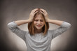© Africa Studio - Cute girl suffering from headache on grey background