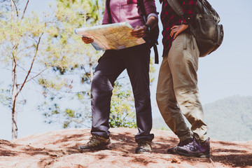 Young couple tourists with map in the park. Adventure.