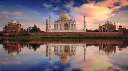 Fototapete - Scenic Taj Mahal sunset view from Mehtab Bagh on the banks of Yamuna river. Taj Mahal is a white marble mausoleum designated as a UNESCO World heritage site at Agra, India.