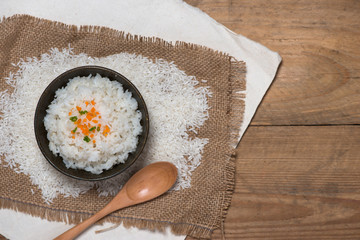 Wall Mural - Close up of cooked rice in wooden in bowl on wooden table