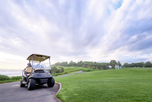 The Golf Course Landscape With Beautiful Sky. Golf Cart At The Green Golf Course.