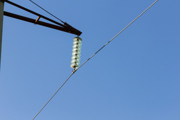 High voltage wire with insulator on blue sky