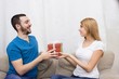 © Saksoni - Guy gives a gift to girlfriend