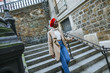Young woman in Paris walking on stairs