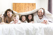© Louis-Paul Photo - Young happy family of five on bedroom