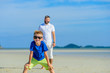 © schamin - Happy father and son at the tropical beach, laughing and enjoing time together