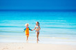 © famveldman - Kids run and play on tropical beach