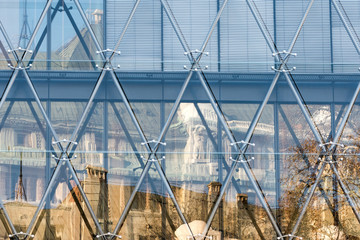 Reflection of old building into the windows of modern structure