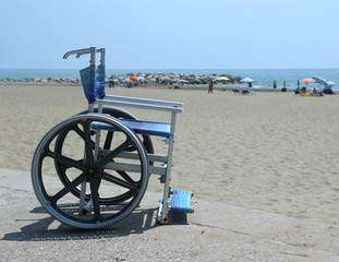 Special wheelchair with big steel wheels to cross the sandy beac