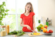 © Africa Studio - Young beautiful woman cutting vegetables in kitchen